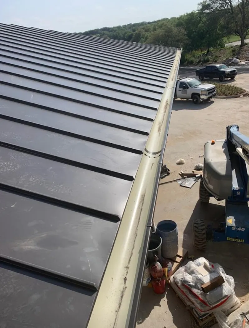 Standing seam panel and gutter detail on a metal roofing jobsite in Waipio